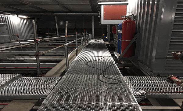Metal catwalk with safety rails and extinguisher