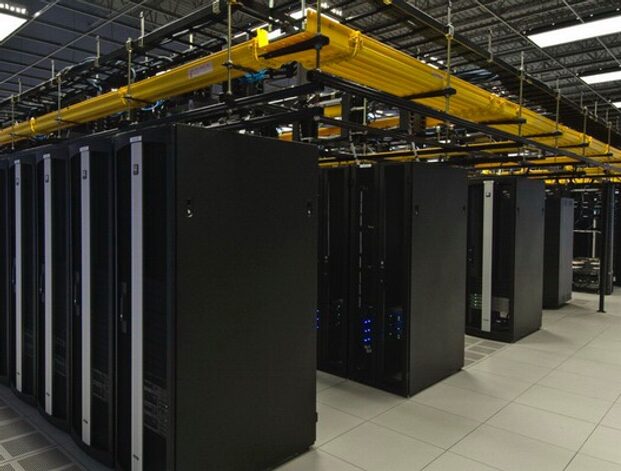 Data center server racks with overhead yellow cabling