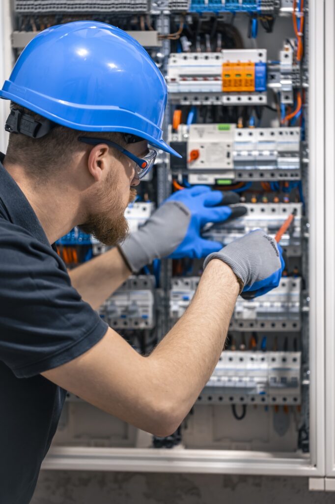 Electrician repairing circuit breaker panel